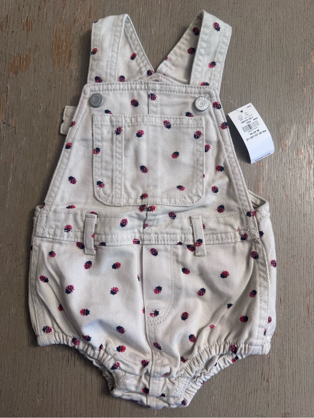 Old Navy Cream Overall Romper with Red and black ladybug Print